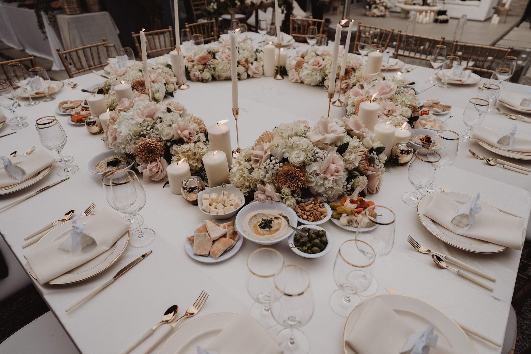 Wedding table with white florals and Moroccan small plates.
