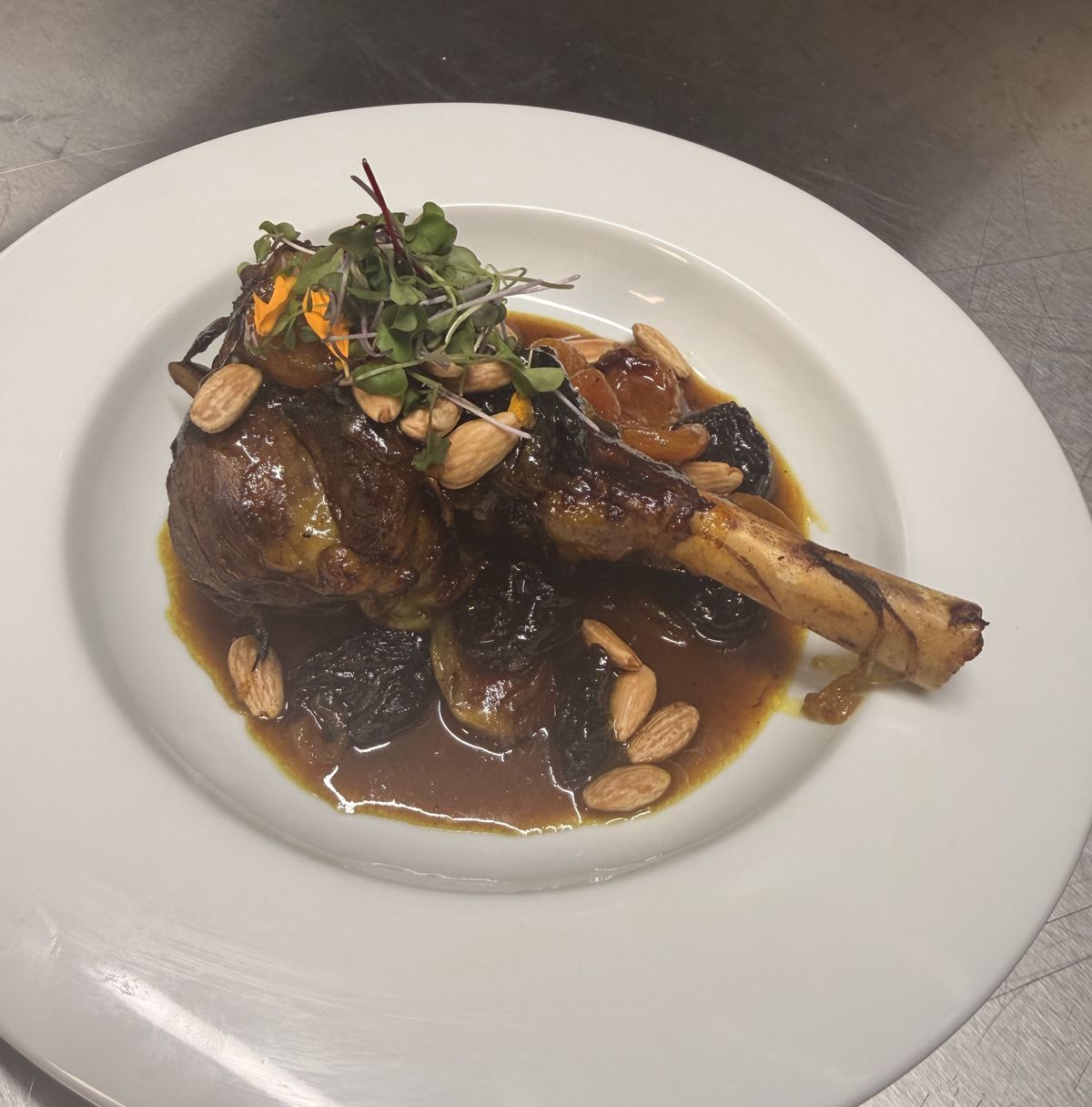 Braised lamb with almonds and herbs in a deep sauce.